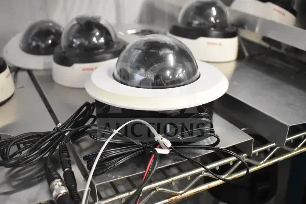 8 Bosch Flexidome IP 5000 HD indoor security cameras on shelf, with cables. Cameras in good condition.