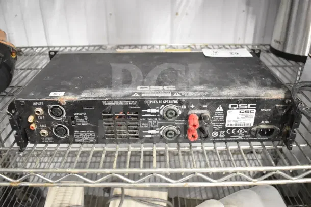 QSC GX5 Power Amplifier, used condition, with input/output connections and venting. Labels visible for model and safety info.