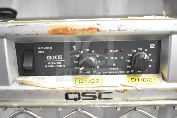 QSC GX5 Power Amplifier with visible rust and wear, labeled C1/C2 and D1/D2.