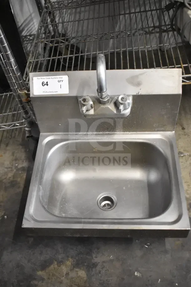 Commercial single bay sink with faucet and handles, stainless steel, fair condition, auction tag numbered 64.