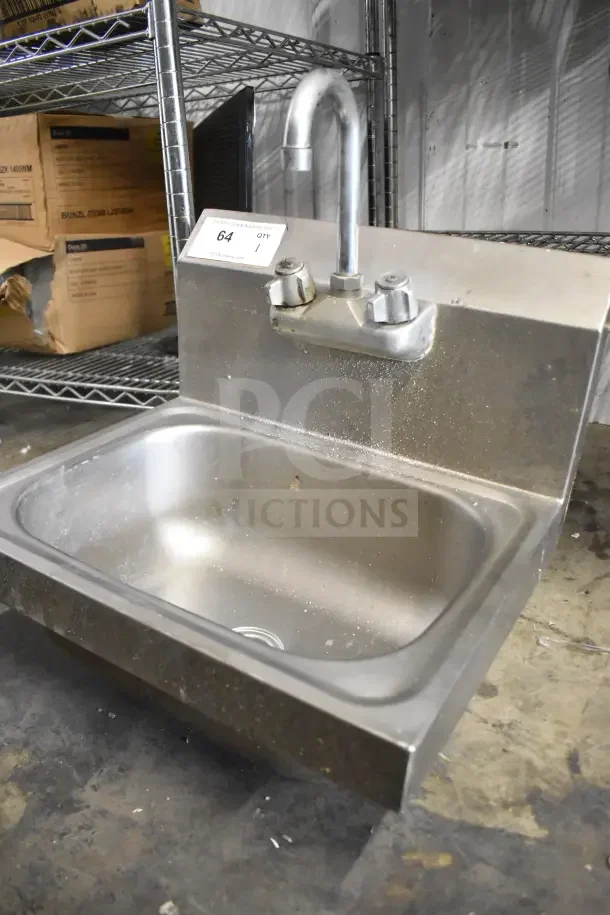 Commercial single bay sink with faucet and handles, stainless steel, visible wear, auction tag labeled "64 QTY 1".