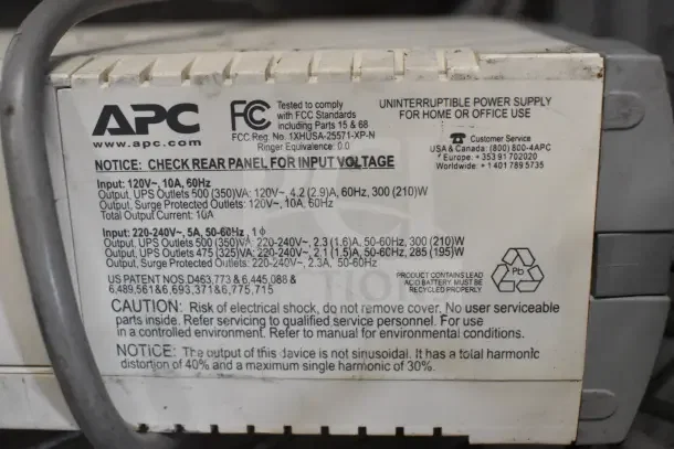 Two APC Back UPS CS 350 units with detailed voltage and output specs label, good condition, ideal for power backup.
