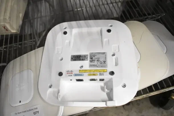 6 Cisco AIR-CAP3502I-A-K9 dual-band access points, ports visible, in used condition on metal shelf.