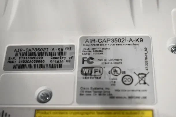 Cisco AIR-CAP3502I-A-K9 Dual Band Access Point, model AIR-CAP3502I-A-K9, WiFi certified, various labels visible.