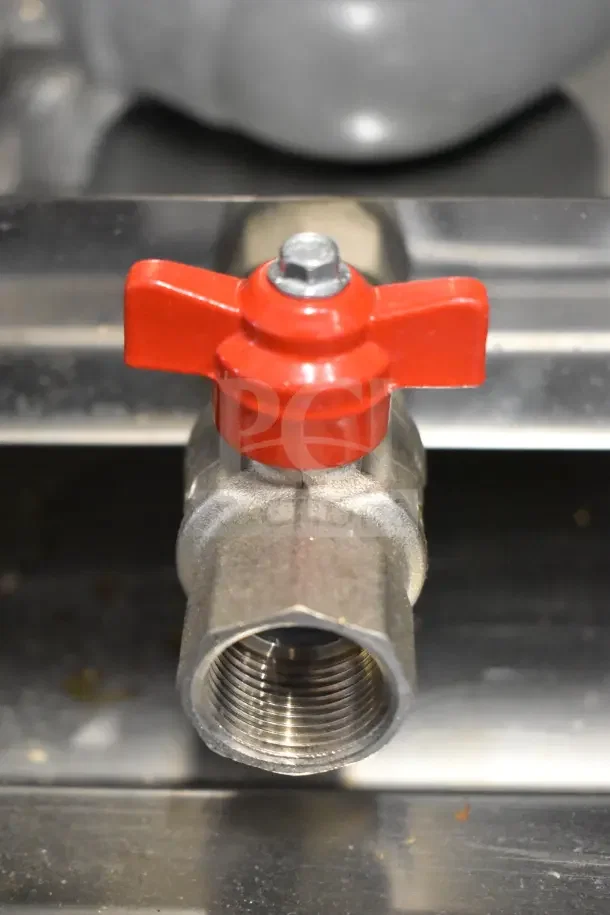 Close-up of a stainless steel oven gas valve with a red handle, part of the Bakers Pride AETG101R combi convection oven.