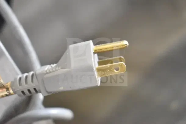Electrical plug close-up, showing a two-prong design with slight wear. Suitable for commercial appliances.
