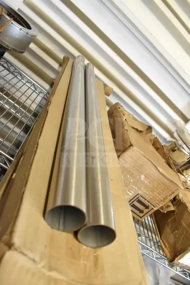 Stainless steel 201SS legs in box, brand new with minor dents, resting on a metal shelf.