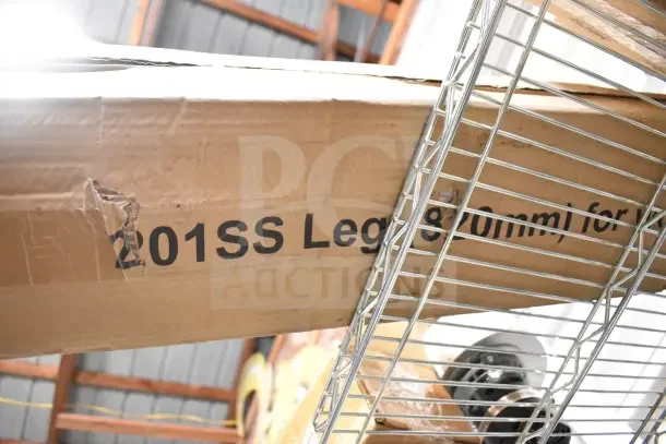 Cardboard box labeled "201SS Legs" with visible scratches and dents, indicating new condition despite exterior wear.