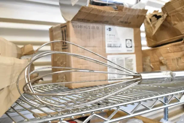 Diversey Prominence cleaner, 8.25 quart Bain Marie pot, whisk attachment, and mini skillets on storage shelf. Auction items.