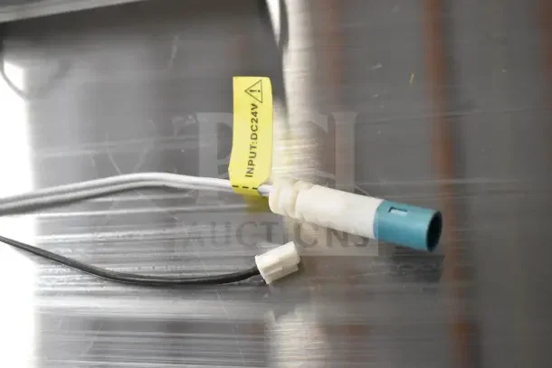 Connector cable with a yellow tag marked "INPUT: DC24V" on a metallic surface, part of the "2 Lights" auction item.