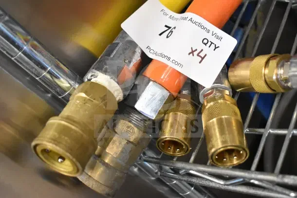 Four various hoses with brass fittings, labeled "QTY x4" for auction. Mixed materials, visible wear.