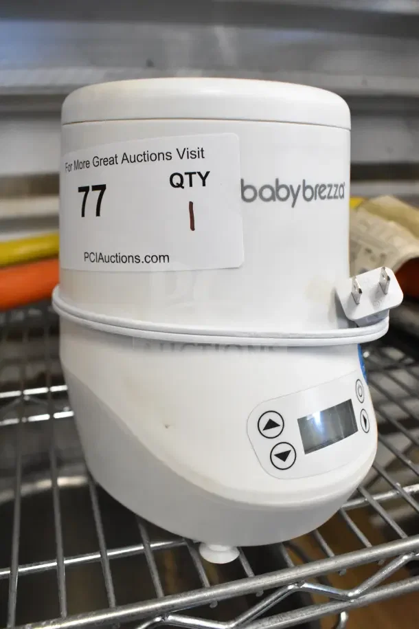 Baby Brezza BZ0105 countertop bottle warmer, 120V, visible controls, and digital display. Minor wear, auction label attached.