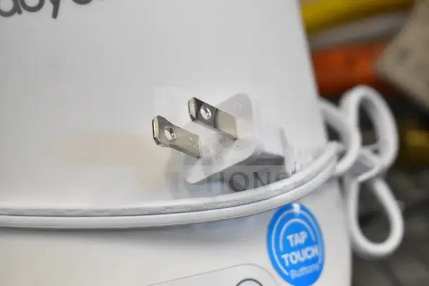 Baby Brezza BZ0105 Countertop Bottle Warmer plug and cord close-up. Features tap touch button, 120 volts, 1 phase.