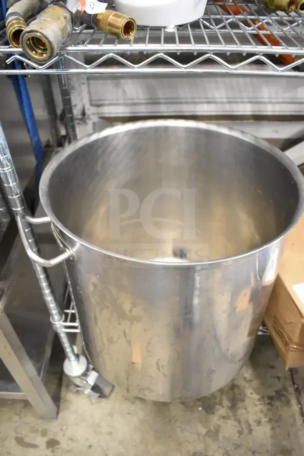 Large stainless steel stock pot, industrial size, with side handles. Good condition, suitable for commercial kitchen use.