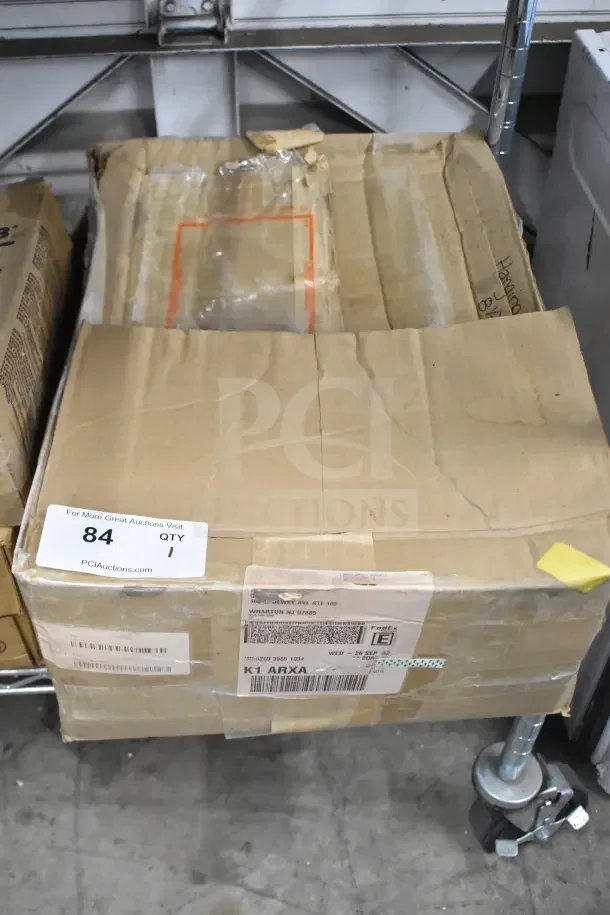 Box of hanging file folders in a worn cardboard box with shipping labels and auction sticker labeled "84 QTY 1".
