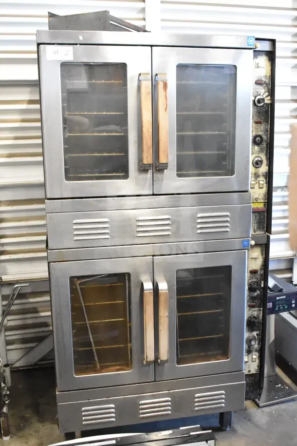Two Vulcan full-size convection ovens with view-through doors and thermostatic controls, display label indicating auction lot.
