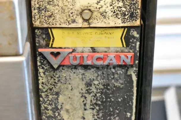 Vulcan logo on a full-size convection oven with visible wear. Includes company tag from D & E Service Company.