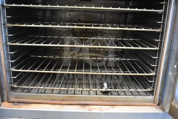 Vulcan full-size convection oven, view-through doors, thermostatic controls, multiple racks, slight wear visible.