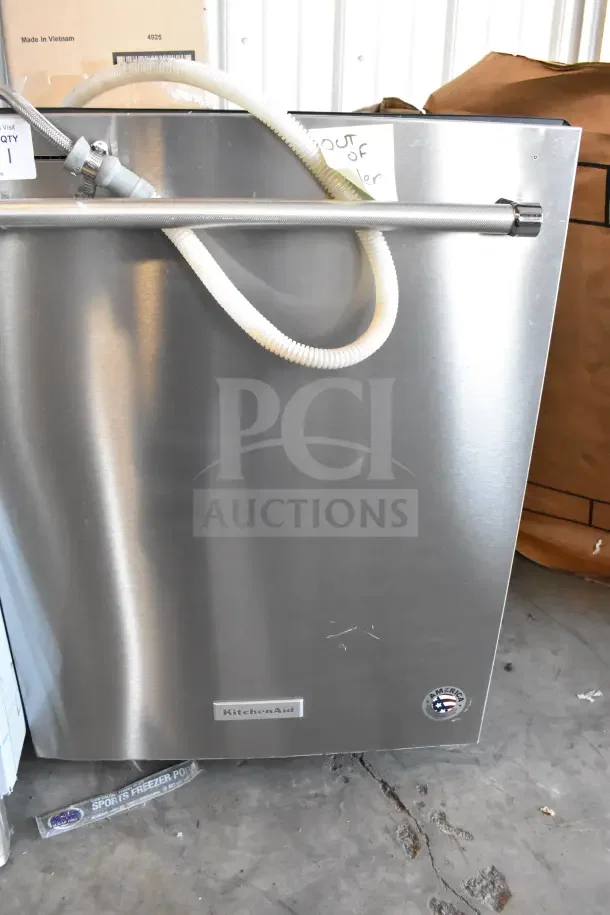 KitchenAid KDTM404KPS undercounter dishwasher, stainless steel, 115 Volts, with visible hoses, minor surface scratches.