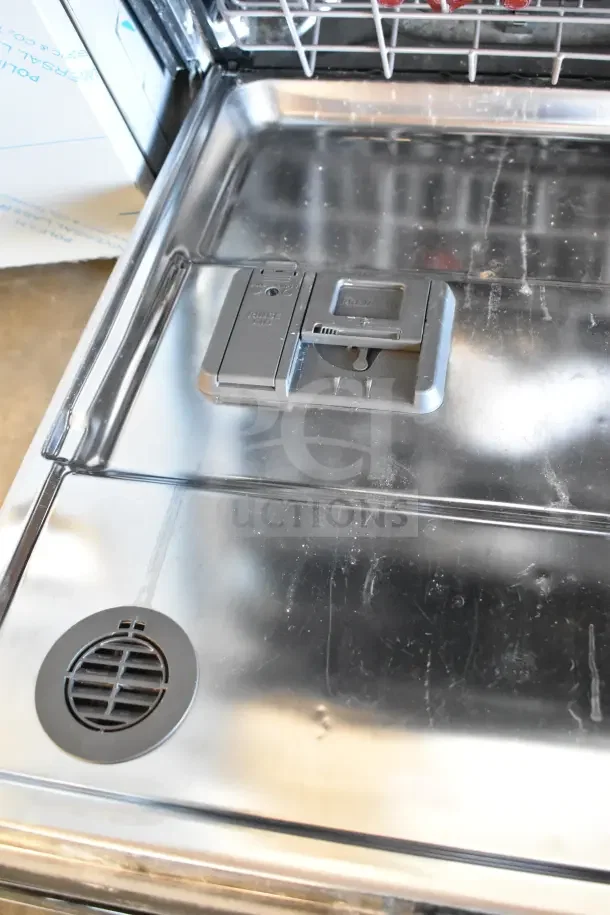 KitchenAid KDTM404KPS dishwasher interior, showing detergent compartment and stainless steel finish.