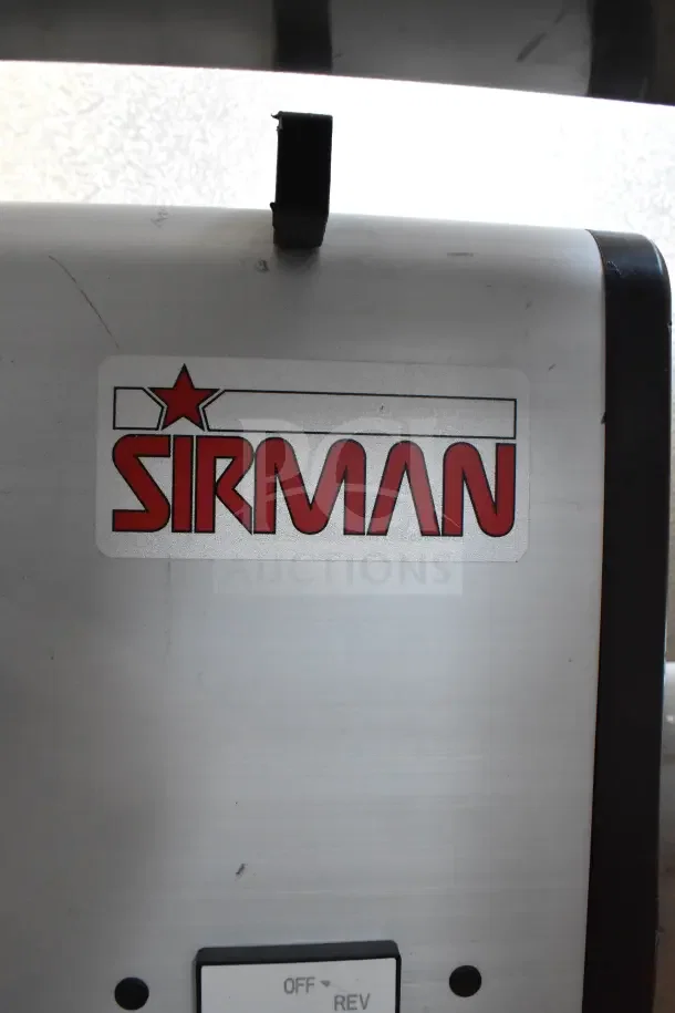 Brand new Sirman countertop meat grinder, 115 volts, 1 phase. Scratch and dent condition. Sirman logo visible.