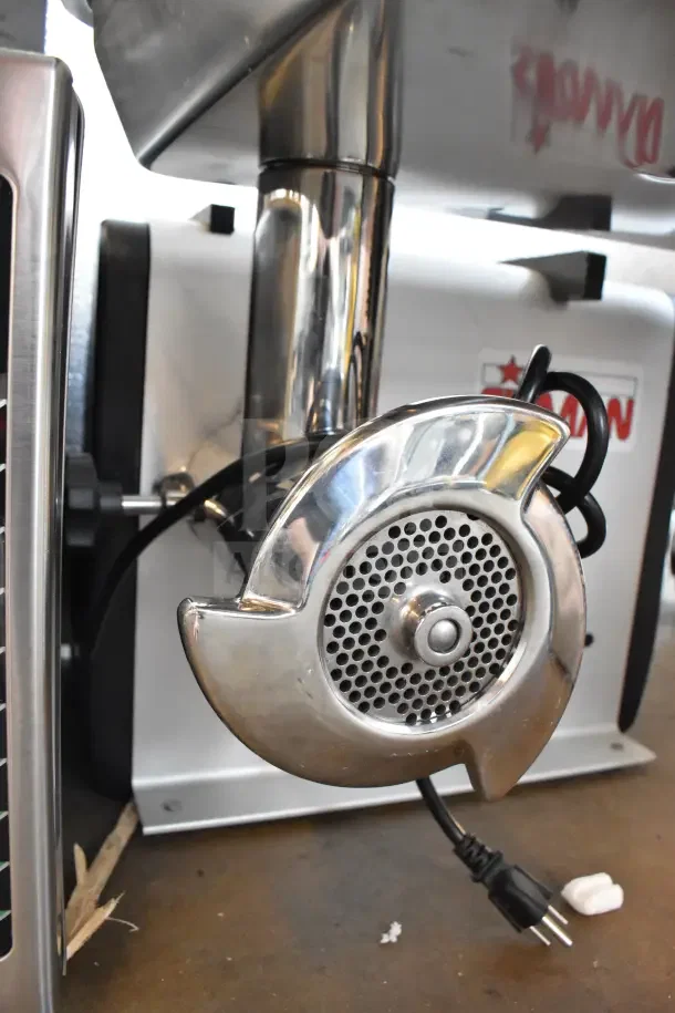 BRAND NEW Sirman countertop meat grinder, 115V, 1 phase, stainless finish, slight scratch and dent, model label visible.
