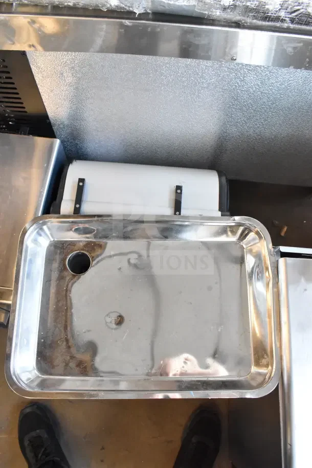 Brand new Sirman countertop meat grinder, showing slight scratch and dent imperfections, 115 volts, 1 phase.