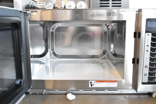Brand new Amana RCS10TS commercial microwave oven, 120V, 1 phase, open door view, minor cosmetic blemishes.