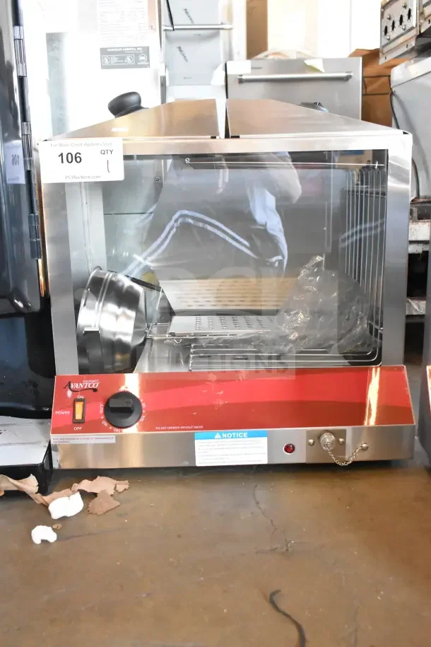 Brand new Avantco countertop hot dog merchandiser with minor scratches. Features stainless steel and glass construction, heating controls, and labeling indicating usage warnings.