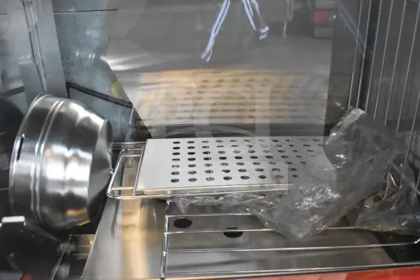 Brand new Avantco countertop hot dog merchandiser with scratches and dents, stainless steel interior, perforated tray.