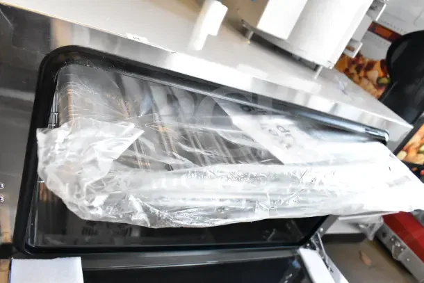 Brand new Avantco 177CO16 half-size countertop convection oven, 1.5 cu. ft., 120 volts. Minor scratches, visible packaging.