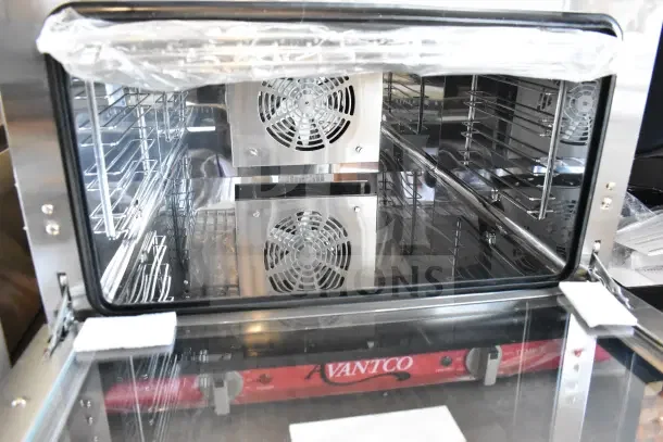 Brand new Avantco 177CO16 half-size convection oven, 1.5 cu. ft., visible tags, 120 volts, slight scratches and dents.