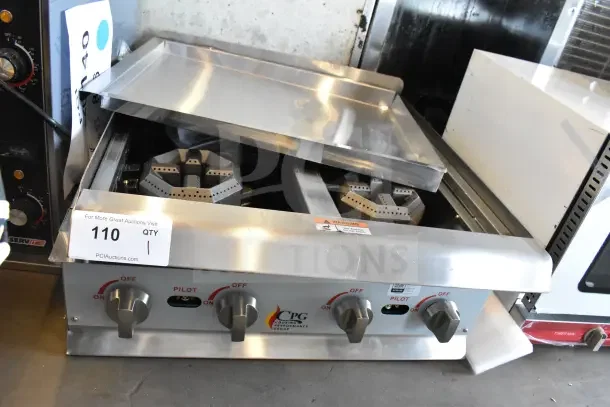 BRAND NEW Cooking Performance Group 4 Burner Gas Range, 88,000 BTU, countertop, no grates, some dents, model R-CPG-24-NL.