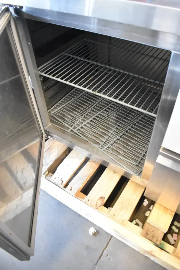 Brand new scratch and dent Avantco commercial undercounter cooler with door open, shelving visible; 115 volts, 1 phase.