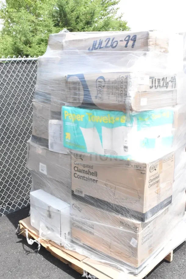 Pallet of assorted items including paper towels, clamshell containers, and other packaging, all shrink-wrapped. Marked JUL26-99.