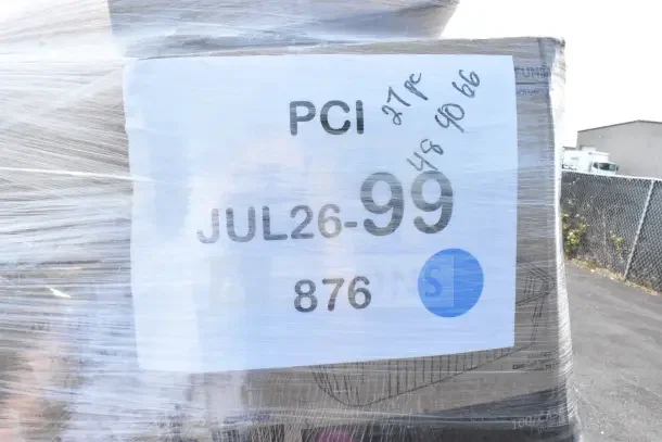 Large, plastic-wrapped pallet labeled "JUL26-99," containing 27 new scratch and dent items like shopping bags and containers.