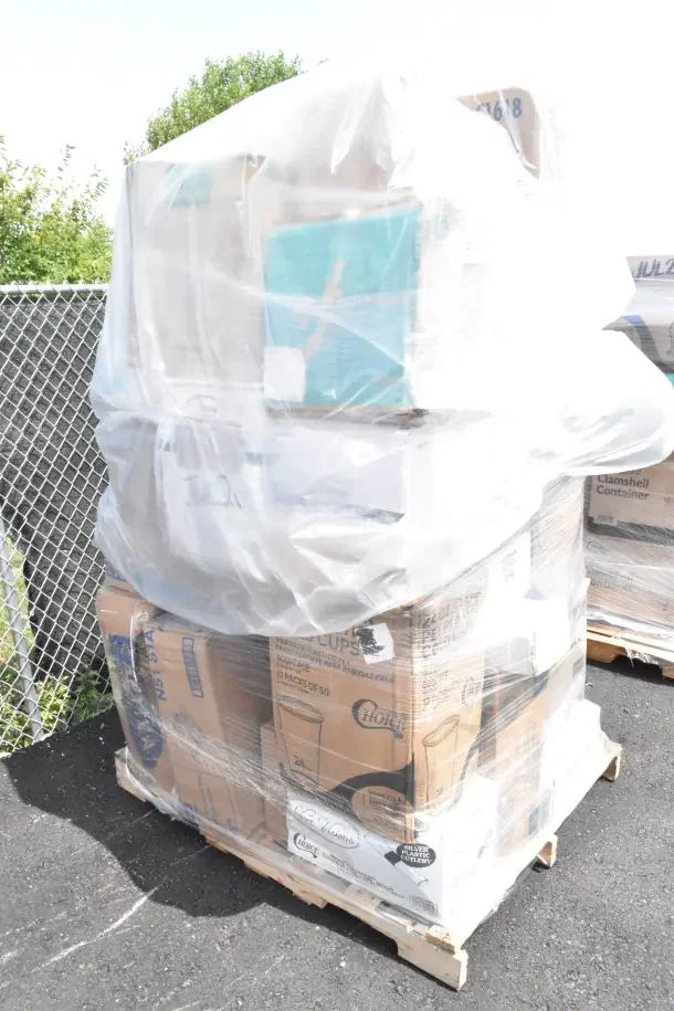 Pallet of 36 new scratch and dent items including plates, cups, bags, liners, and shot glasses, wrapped in plastic.