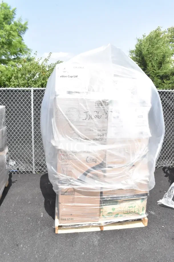 Pallet of 26 new scratch and dent items including lids, cold and hot cups, and plates wrapped in plastic.