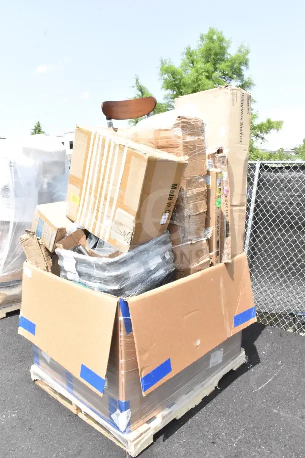 Pallet with 28 new scratch and dent items including boxed chair and hole punch, secured with blue tape.
