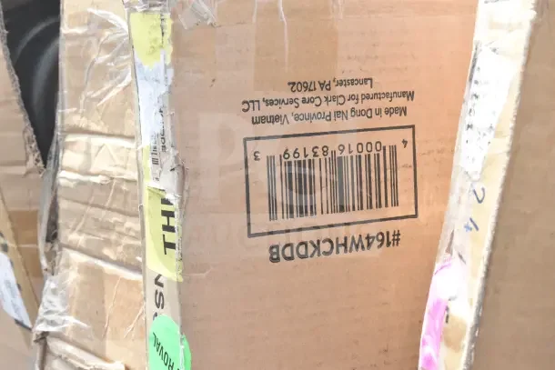 Cardboard box with visible wear, showing a barcode and text indicating the box is for Clark Core Services LLC. Contains scratch and dent items.
