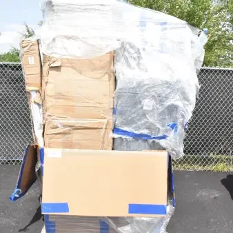 Large stack of boxed items on a pallet, wrapped in plastic. Includes brand new, scratch and dent tables. Visible label reads “126.”