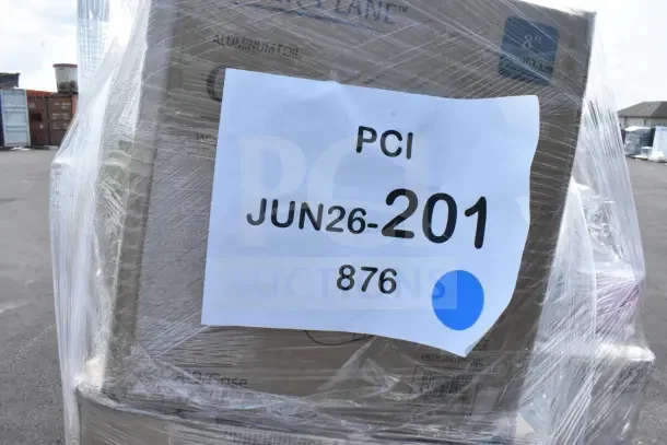 Plastic-wrapped pallet of assorted scratch-and-dent items including straws and foodservice film. Visible label: "PCI JUN26-201".
