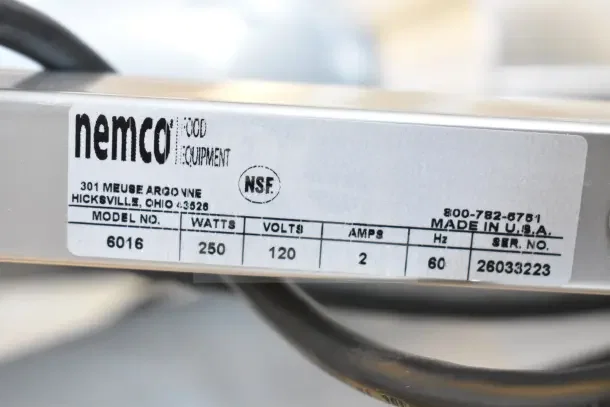 Alt text: Close-up of label on a Nemco 6016 carving station. Indicates model, watts, volts, amps, and U.S. origin.