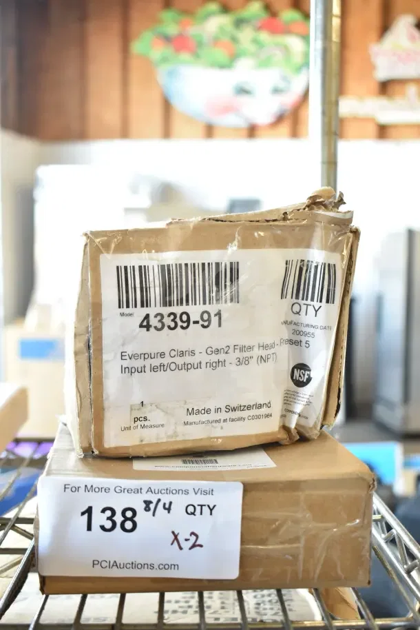 Two boxed items, Everpure EV4339-91 Claris Gen 2 filter head and Hatco 05.30.069.00 legs, labeled "scratch and dent."
