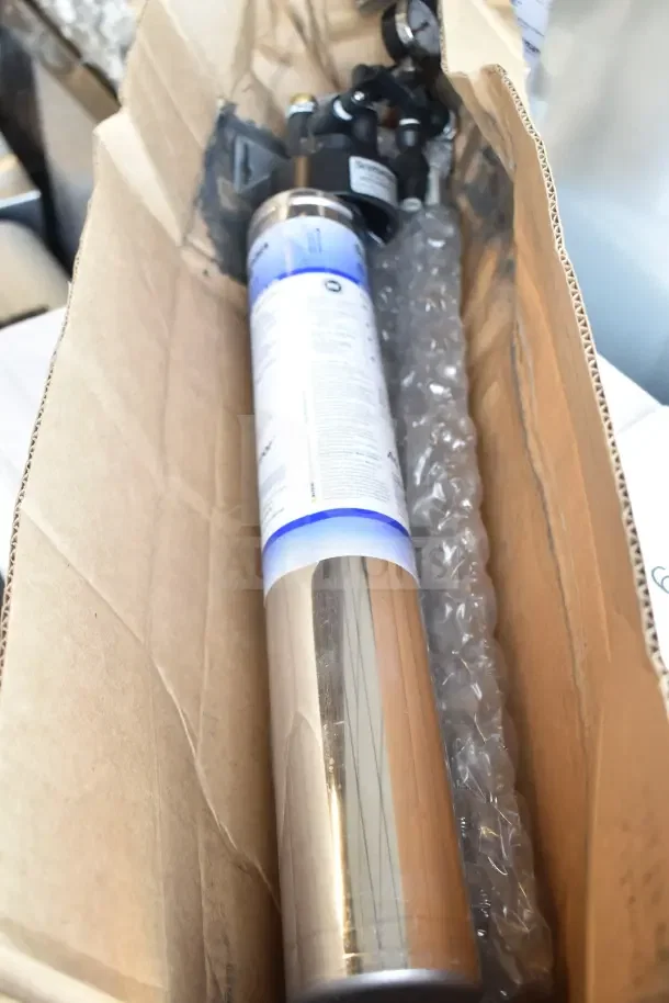 "Brand new scratch and dent Scotsman KUFM15 floor mount kit in cardboard box, visible steel cylinder and bubble wrap protection."