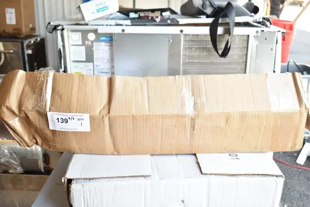 Scotsman KUFM15 Floor Mount Kit in damaged cardboard box, marked as brand new with scratch and dent condition.