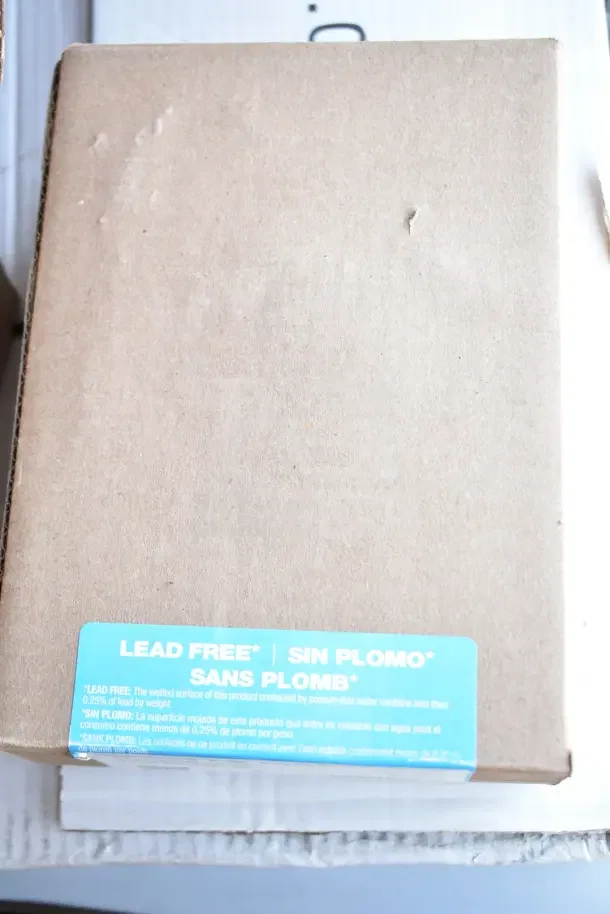 Cardboard box of Watts LFN250B-Z2-020 water pressure regulator, marked "LEAD FREE," minor scratches visible.