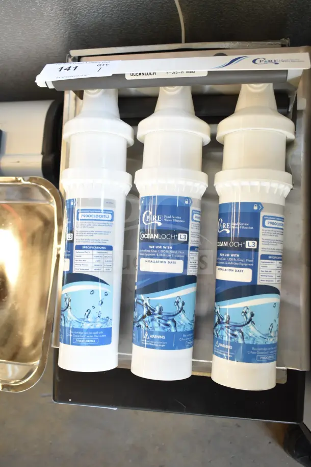 BRAND NEW C Pure Oceanloch+ L3 water filtration system, 3 cartridges, 1 micron rating, 5 GPM, scratch and dent condition.