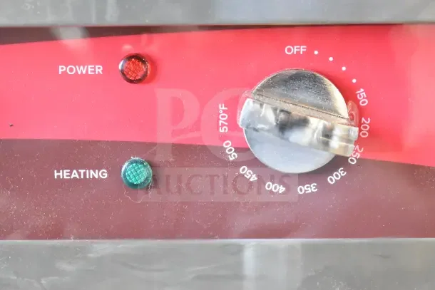 Avantco EG24N electric griddle controls, showing power and heating lights, with temperature dial ranging up to 570°F.