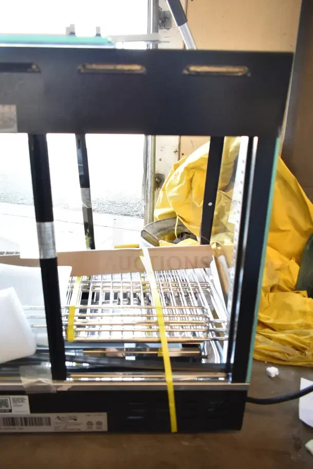 Avantco 177HDC26 heated display case, new scratch and dent, 3 shelves, sliding doors, 120V, 1 phase, labeled base.
